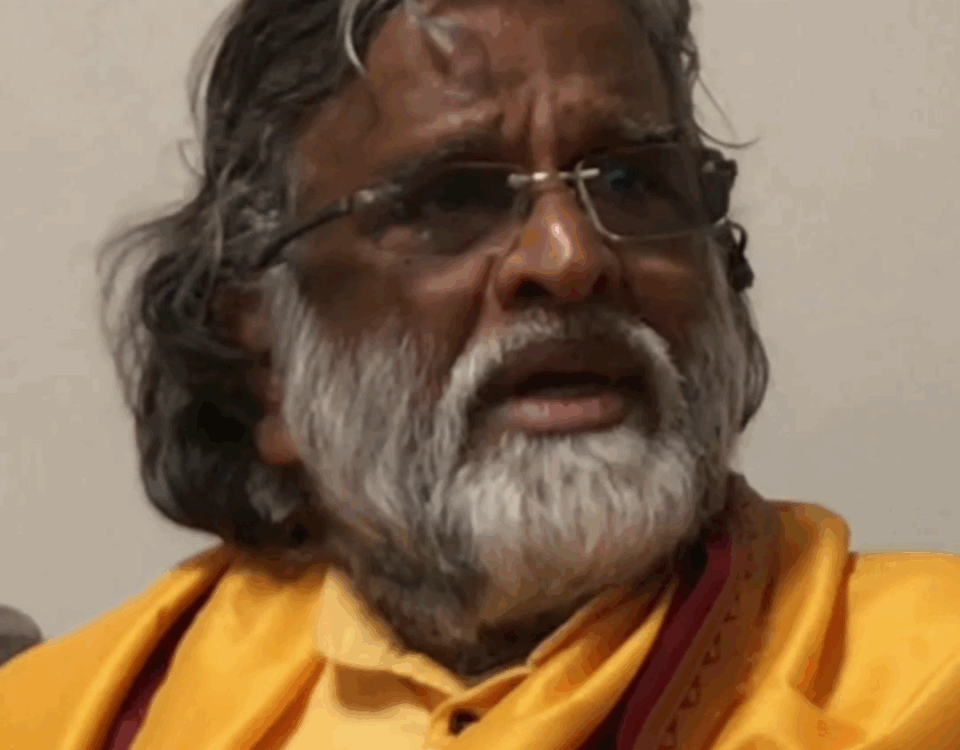 Person meditating in peaceful natural setting symbolizing spiritual self-discovery during Satsang