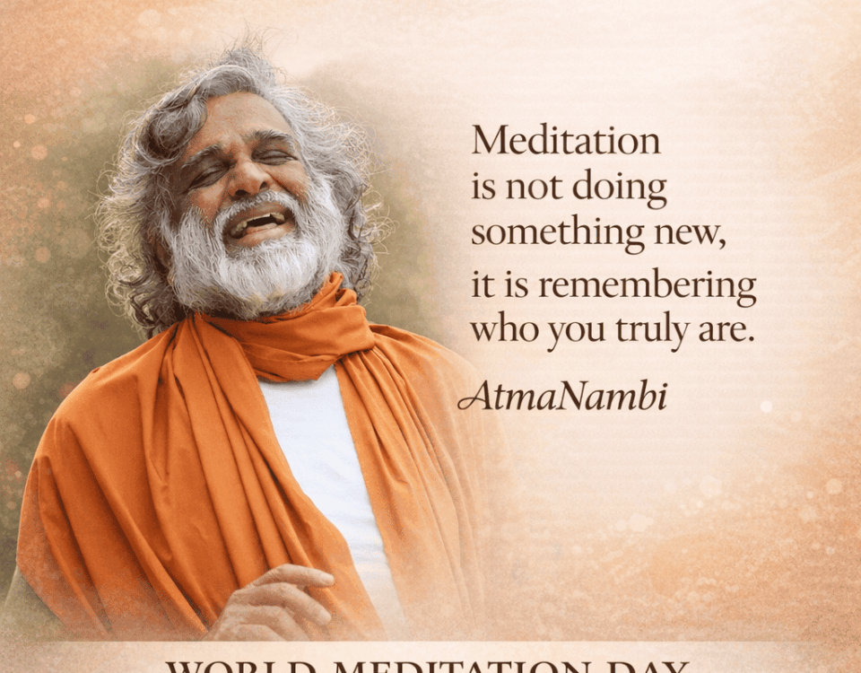 AtmaNambi smiling in orange robes sharing wisdom on the true meaning of meditation for World Meditation Day.