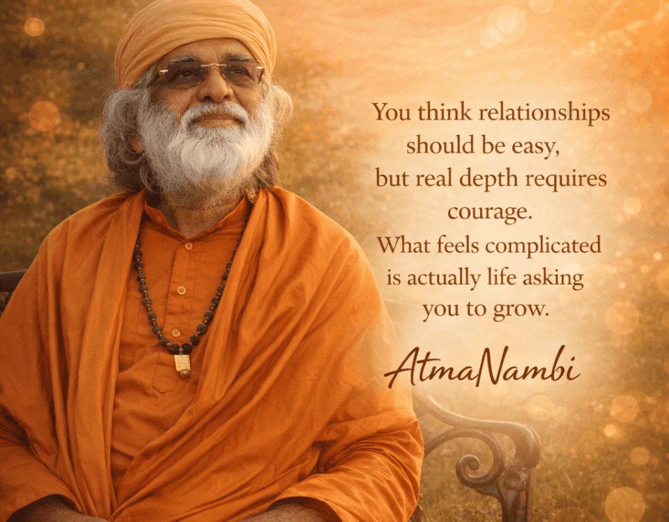 Enlightened Master AtmaNambi smiling in orange robes featuring an inspiring quote about courage and spiritual growth in relationships.