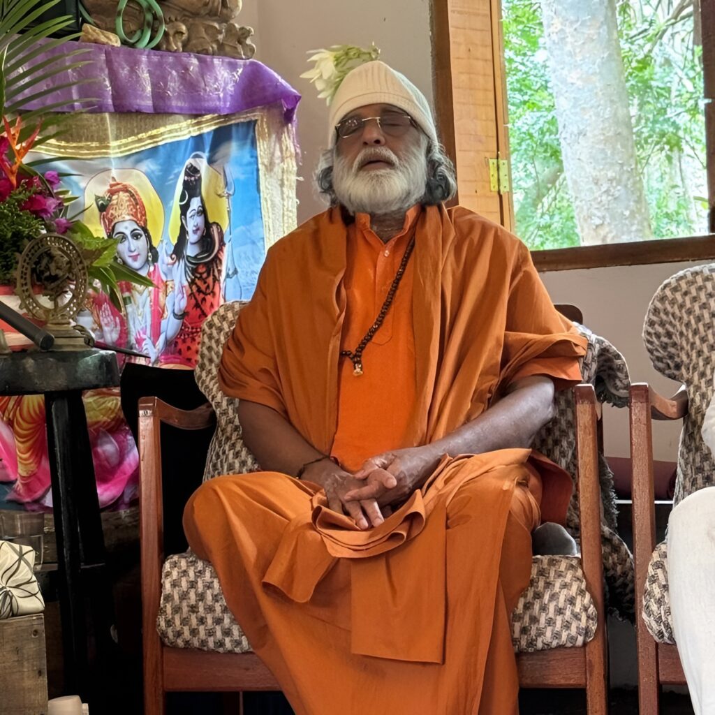Guru AtmaNambi smiling during the Mass Awakening Brazil spiritual journey, surrounded by devotees at a satsang.