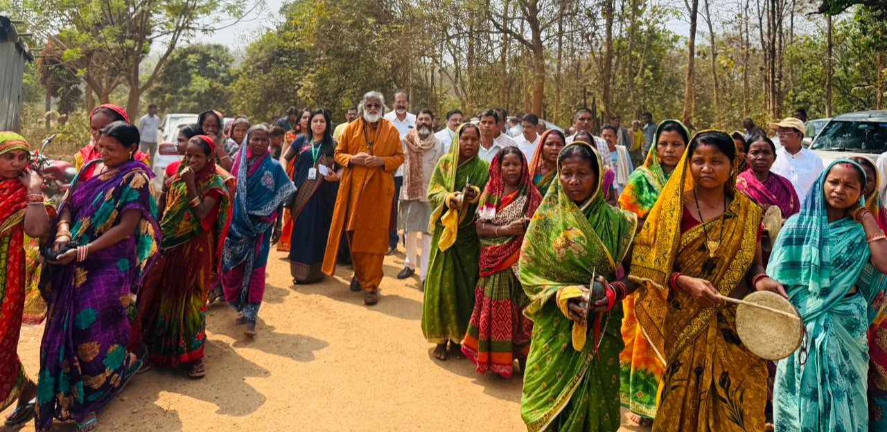 Local tribal women in traditional attire lovingly accompany the master during an AtmaNambi spiritual service tour in the Dhenkanal district.