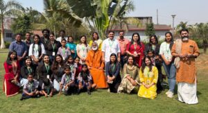 A joyous community of volunteers, children, and locals gather around the enlightened master during an AtmaNambi spiritual service initiative in Odisha.