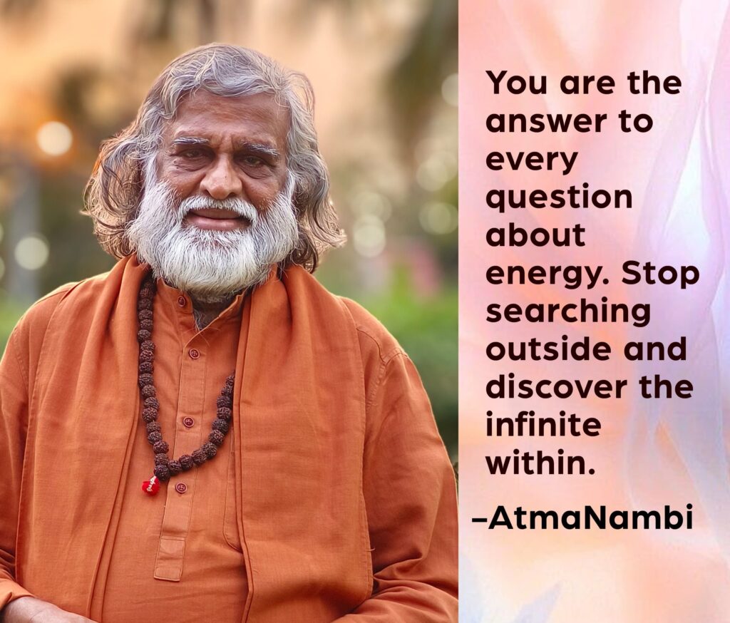 AtmaNambi spiritual quote poster showing the enlightened Indian master seated in meditation posture wearing orange kurta and rudraksha beads, sharing his teaching to discover infinite energy within and stop searching outside.