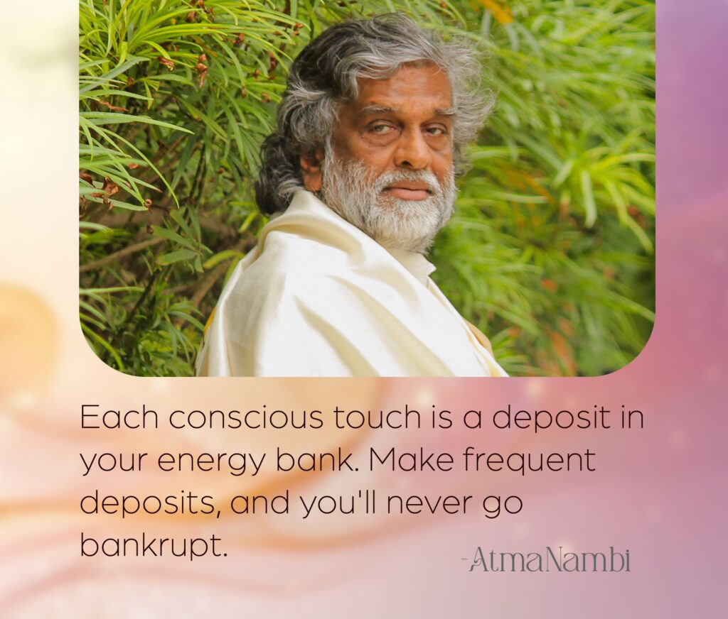 AtmaNambi spiritual poster with quote on conscious touch as energy bank deposits, featuring the enlightened master in white robes amid lush green foliage with a steady, grounded gaze.
