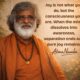 AtmaNambi spiritual poster with quote on joy as pure consciousness when the mind dissolves into awareness, featuring the enlightened master in rust-orange robes with a rudraksha mala against a warm golden bokeh background.