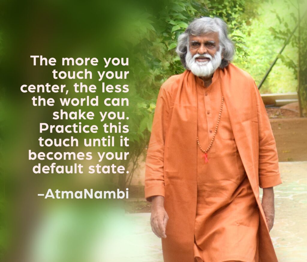 AtmaNambi, Indian enlightened master in saffron robes walking serenely, with his inner stillness spiritual teaching: "The more you touch your center, the less the world can shake you."