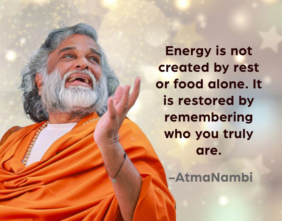 AtmaNambi, Indian enlightened master in saffron robes with an upward joyful gaze, sharing his restore energy true self spiritual teaching: "Energy is restored by remembering who you truly are."