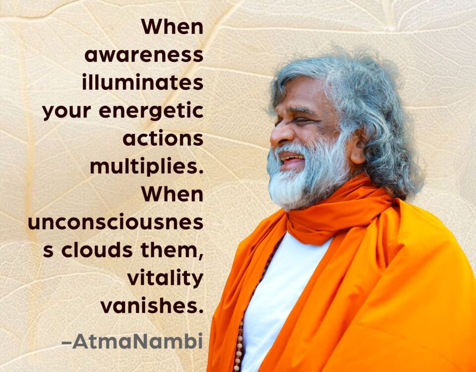 AtmaNambi, Indian enlightened master in saffron robes smiling radiantly, sharing his awareness multiplies energy spiritual teaching on how consciousness amplifies vitality and unconsciousness diminishes it.