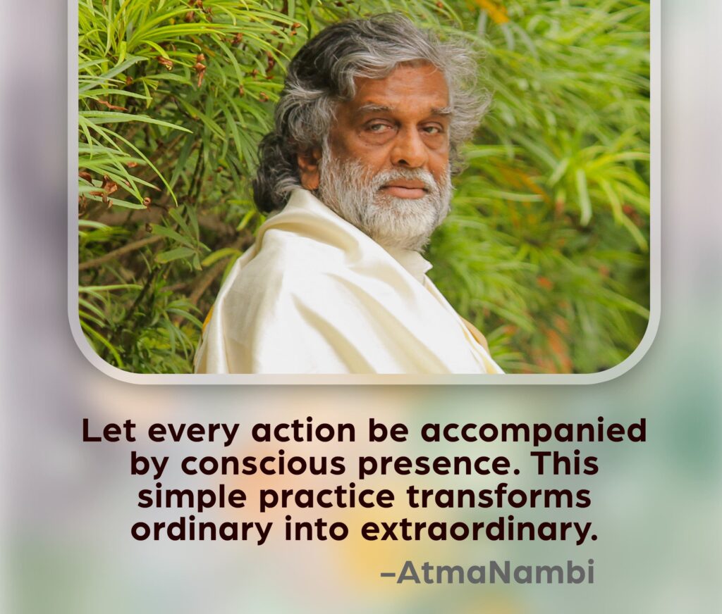 AtmaNambi, Indian enlightened master in white robes seated amid lush greenery with a deeply aware gaze, sharing his conscious presence spiritual teaching that transforms ordinary actions into extraordinary ones.