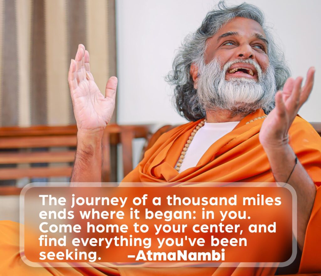 AtmaNambi speaking with open hands and upward gaze, sharing his teaching on coming home to your inner center as the destination of every spiritual journey.