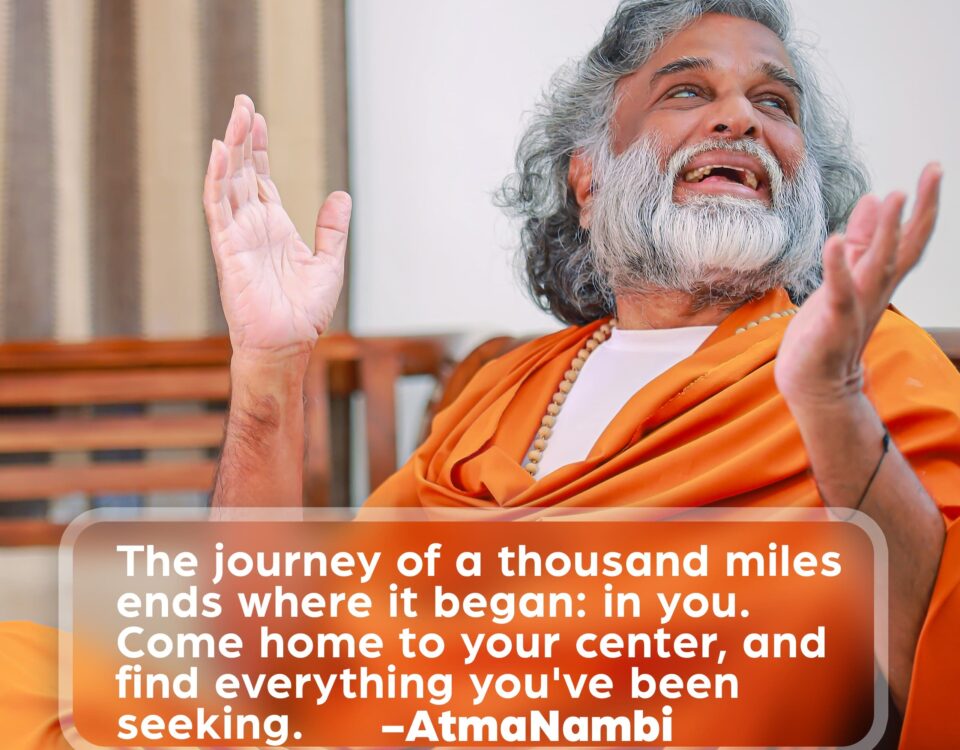 AtmaNambi speaking with open hands and upward gaze, sharing his teaching on coming home to your inner center as the destination of every spiritual journey.