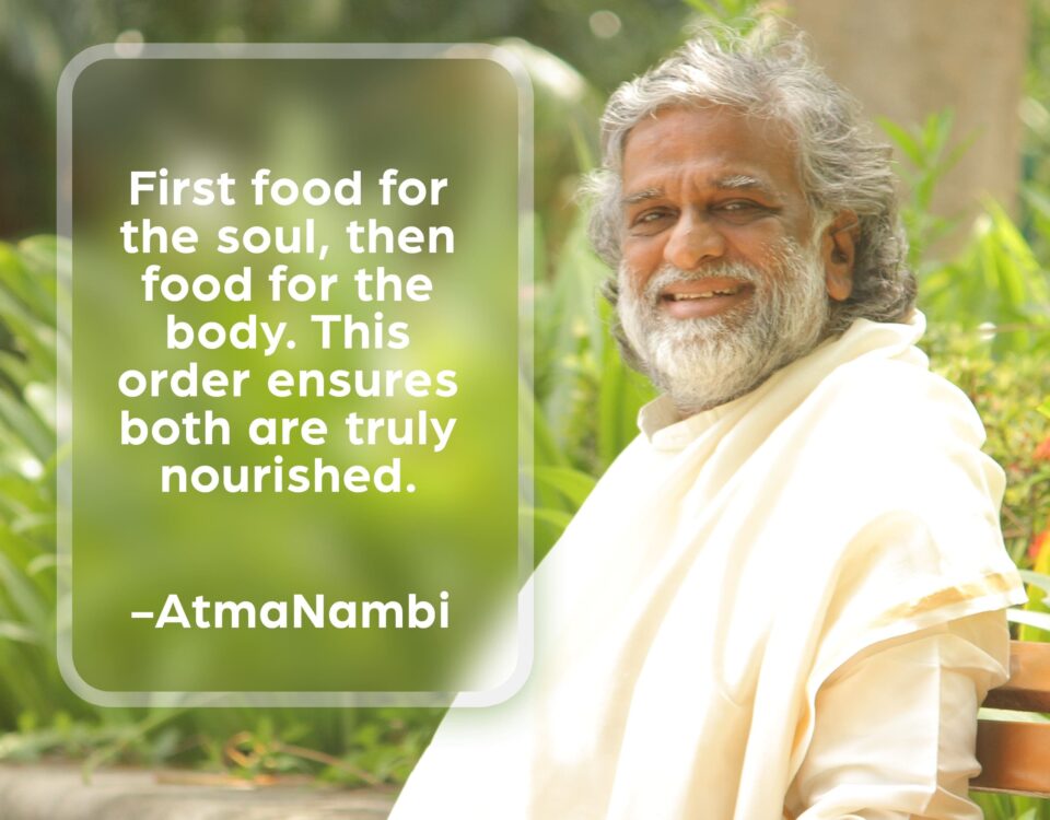 AtmaNambi seated serenely outdoors, sharing his teaching on nourishing soul and body — that feeding the inner life first ensures both are truly sustained.