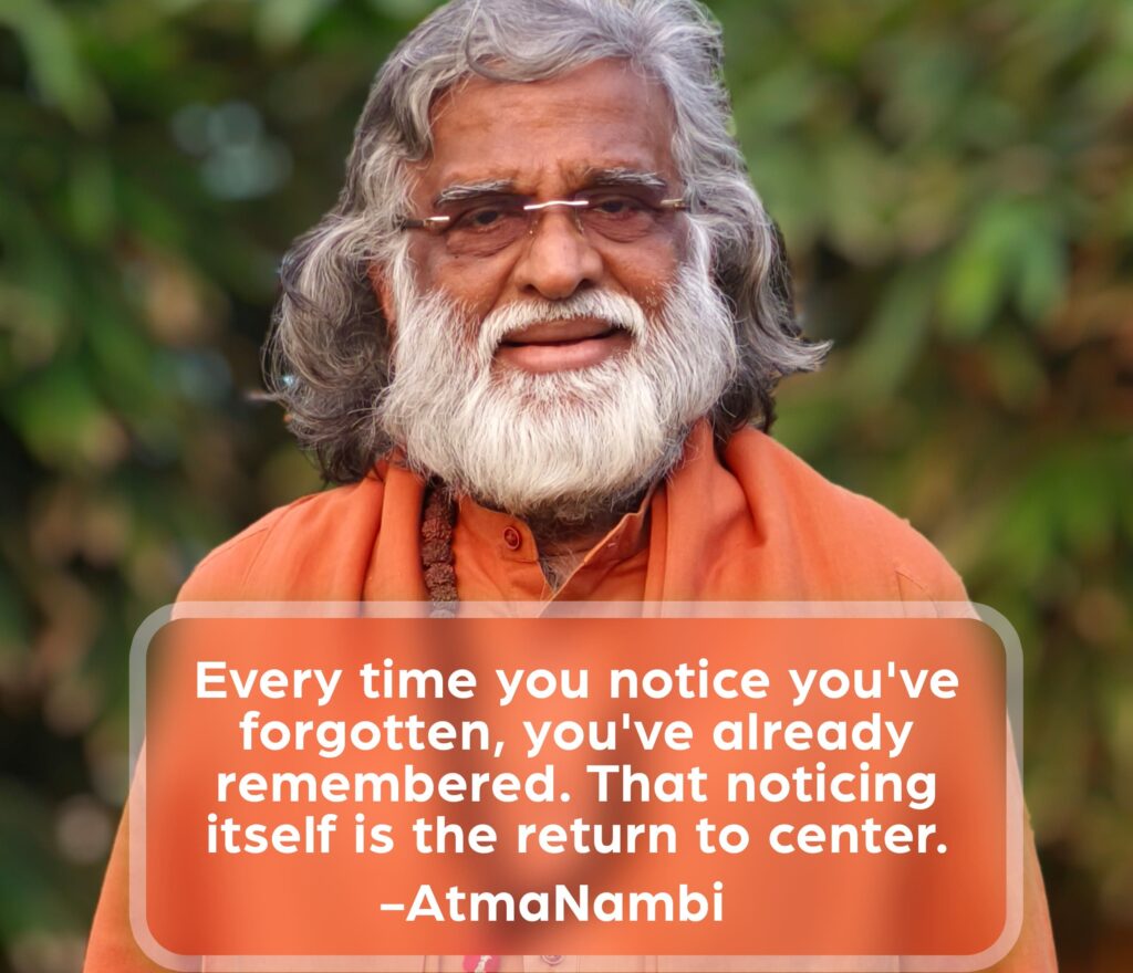 AtmaNambi in an earnest, direct gaze outdoors, sharing his teaching on return to center — that the very act of noticing you've forgotten is already the moment of remembering.